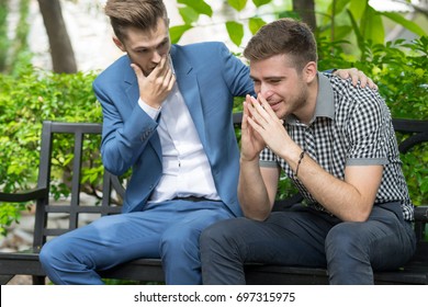 Man Consoling Sadness Friend He Closing His Face, Crying And Feeling Upset Cause From His Mistake In The Park.Breakup Concept