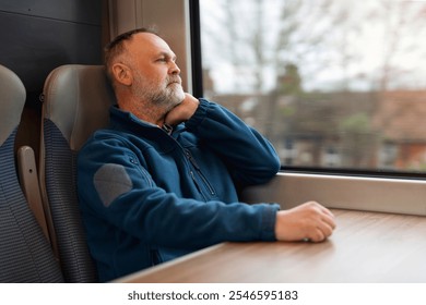 Man contemplating during train journey while gazing out of window on a quiet afternoon - Powered by Shutterstock