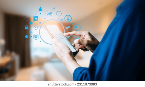 Man controlling his living environment through home automation technology, enhancing his overall comfort and convenience, Concept of innovation in the context of smart home technology.  - Shutterstock ID 2311073083