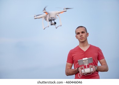 Man controls a quadrocopter. Selective focus on men, drone is blurred