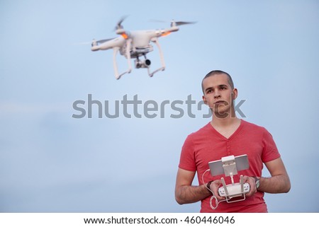 Man controls a quadrocopter. Selective focus on men, drone is blurred