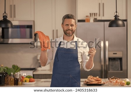 man cook delicacy salmon hold knife. man cook delicacy salmon fish. man cook delicacy salmon