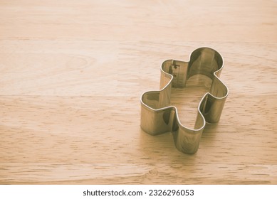 Man cookie cutter on wooden table background copy space. Human resource (HR) in business company, headhunter recruitment, job interview and course training development skill concept.