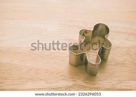 Man cookie cutter on wooden table background copy space. Human resource (HR) in business company, headhunter recruitment, job interview and course training development skill concept.