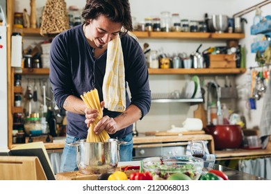 Man Cooking At His Kitchen