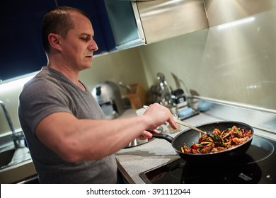 Man Cooking At Home Alone A Thai Recipe In Wok Pans