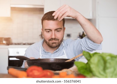 Man Cooking At Home And Preparing Food