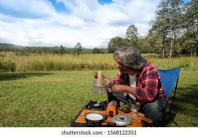Man cooking instant noodle with boiling in pitch pot during camping
Camping food.Quick and easiler cooking noodle.Instant noodles is tasty fastfood.Boiling water in a pot,Thailand called Mama noodles.