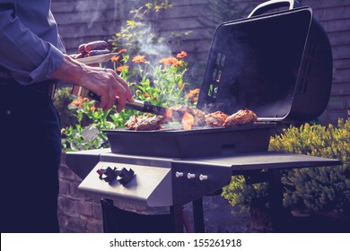 Man cooking meat on barbecue