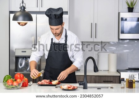 Man cooking in modern kitchen. Man doing housework at home, preparing breakfast in kitchen. Handsome man is cooking on kitchen. Hispanic man cooking healthy food in kitchen.