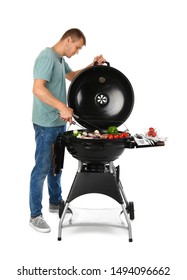 Man cooking on barbecue grill, white background