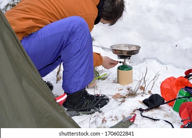 Man Cooking on a Propane Canister Stove on a Winter Camping Trip
