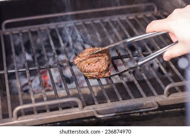 Man Cooking Steak On The Grill 