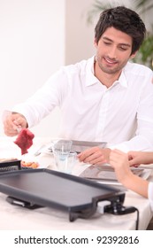 Man Cooking Steak On A Table Top Plate