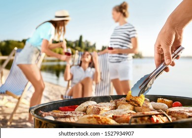 Man cooking tasty food on barbecue grill outdoors, closeup - Powered by Shutterstock