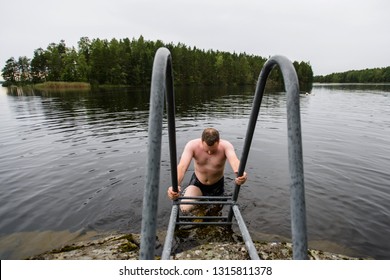 Man Cooling Down At Water After Taking Finnish Sauna