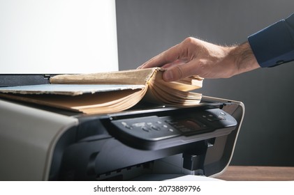 Man Copying A Book On A Copy Machine.