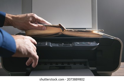 Man Copying A Book On A Copy Machine.