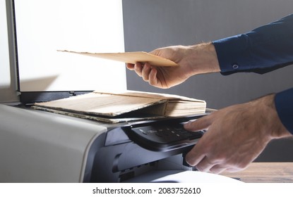 Man Copying A Book On A Copy Machine.