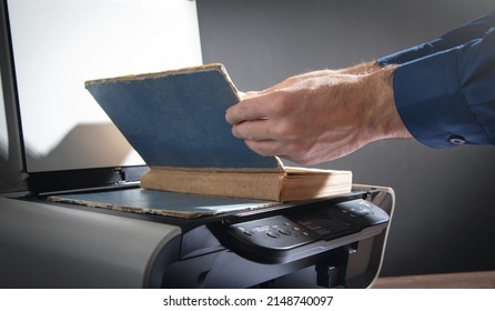 Man Copying A Book On A Copy Machine.