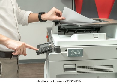 Man Copying Paper From Photocopier With Access Control For Scanning Key Card