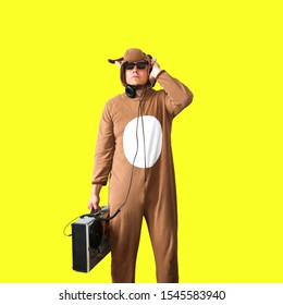 Man In Cosplay Costume Of A Cow With Reel Tape Recorder. Guy In The Animal Pyjamas Sleepwear. Funny Photo With Party Ideas. Disco Retro Music.