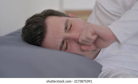 Man Coughing While Sleeping In Bed, Close Up