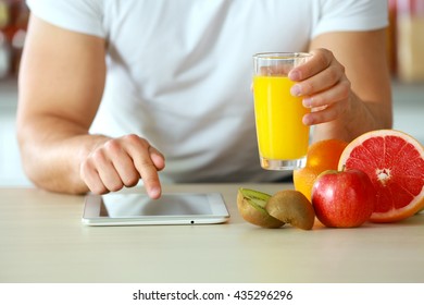 Man Counting Calories On Tablet