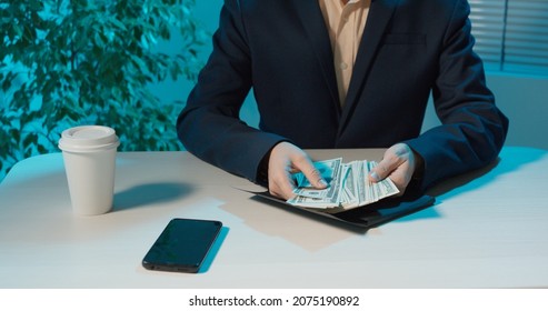 a man counts money at the table. close-up