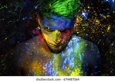 Man covered in glowing colorful powder