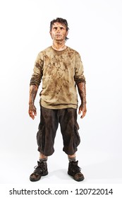 A Man Covered In Mud Trying To Survive