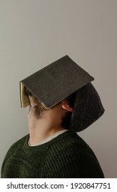 Man Covering His Face With A Gray Task Book