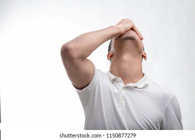 Man covering his face with his hand as he tilts his head back isolated in a front view on white