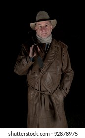 Man With Cowboy Hat, Long Leather Coat And Riot Gun At Night