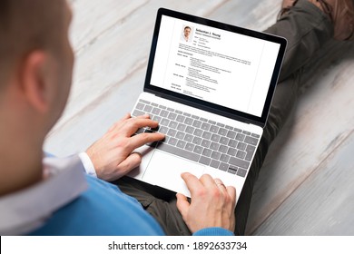 Man creating his CV on laptop. All contents in document are made up.