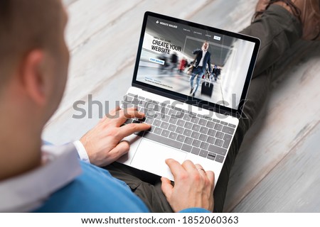 Man creating website for his business by using laptop computer
