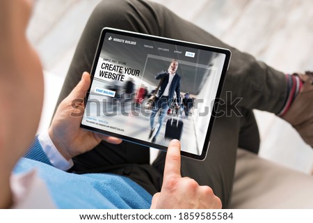 Man creating website for his business by using tablet