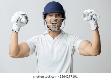 Man In cricket dress with helmet screaming in joy and anger looking towards the camera , Cricketer world cup concept - Powered by Shutterstock