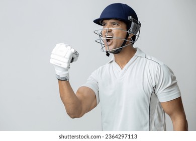 Man In cricket dress with helmet screaming in joy and anger, Cricketer world cup concept - Powered by Shutterstock