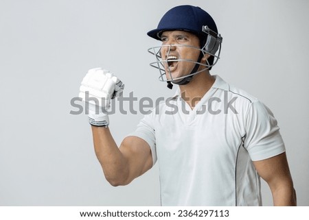 Man In cricket dress with helmet screaming in joy and anger, Cricketer world cup concept