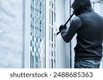 Man, criminal and crowbar for home crime, house invasion and breaking entering attempt with tool. Apartment, robbery and burglary or trespassing on property, security breach and owners safety risk