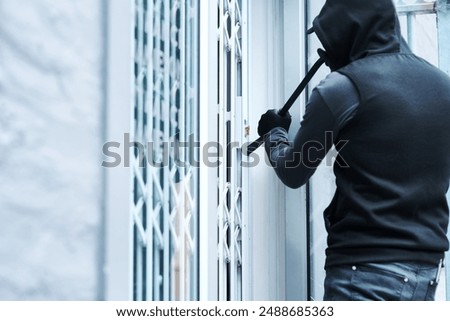Man, criminal and crowbar for home crime, house invasion and breaking entering attempt with tool. Apartment, robbery and burglary or trespassing on property, security breach and owners safety risk