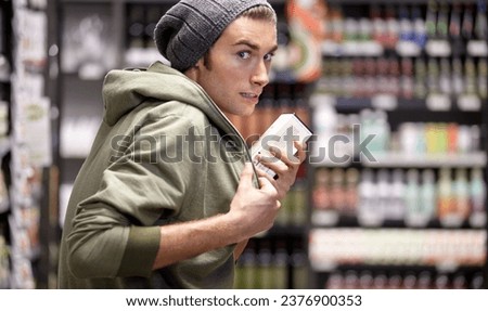 Man, criminal or steal or food in supermarket crime, poverty or hungry homeless sneak. Male person, thief or hide product or shoplifting in grocery shopping store for addiction money, sell or secret