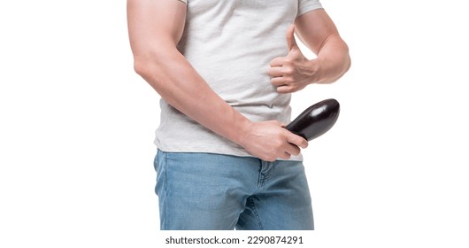 Man crop view giving thumb holding eggplant at crotch level imitating erect penis isolated on white