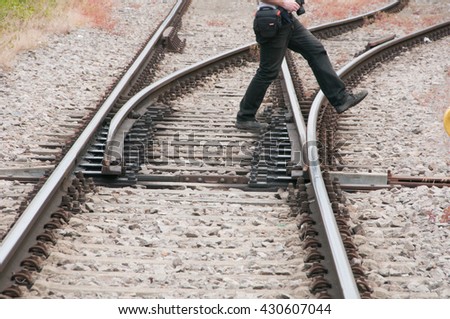 Man crosses railroad rail with diverter