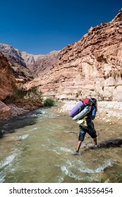 Man Crossing The Creek In Wadi Hasa In Jordan