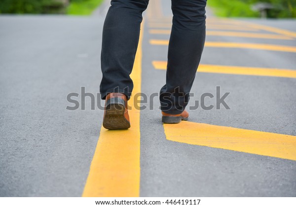 Man\
crossing pedestrian lane. Blurred by\
movement.
