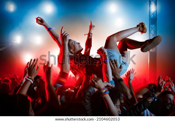 Man crowd surfing at\
music festival