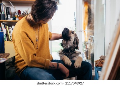 Man Cuddling His Dog Indoor