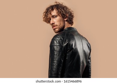 Man With Curly Hair Wearing Laser Jacket Studio Standing Isolated On Bage Background Looking Camera Cool Back View